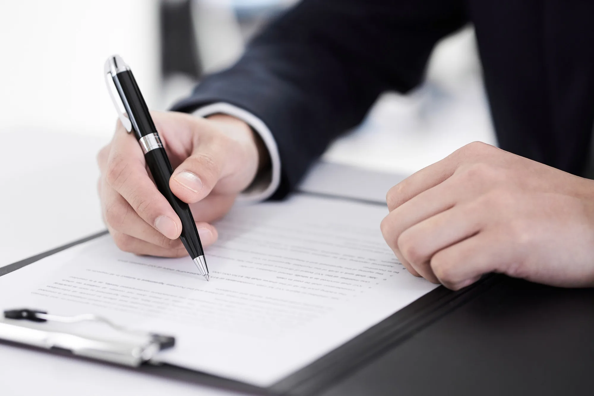 Japanese male businessman on hand to sign papers